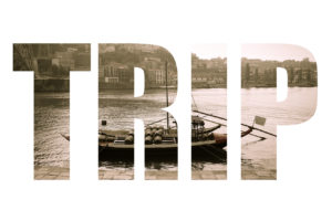 Word TRIP over boat with barrels of wine at the berth. Douro River. city of Porto. Toned